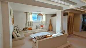 A modern living room with a sofa, a round coffee table, and a decorative vase.