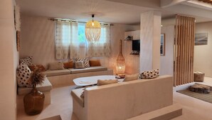A modern living room with a sofa, a coffee table, and a decorative vase.