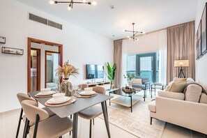 Relax in a spacious living area with a comfortable sofa, dining table, and flat-screen TV.