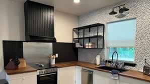 A modern kitchen with a built-in oven, stainless steel appliances, and a wooden countertop. - ꕥ The Texas Bluebonnet ꕥ 1.1 mi to Baylor, & 1.8 mi to Magnolia Silos! (Waco)