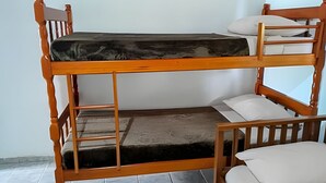 A bunk bed with a wooden frame and a mattress.