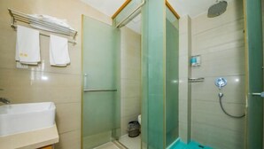 A bathroom with a glass-enclosed shower, a sink, and a towel rack. - Xiangshan Shipu Hongting Hotel (Xiangshan)