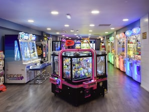 An indoor arcade with claw machines and various gaming machines.
