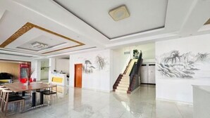 A spacious lobby with a marble floor, a staircase, and artwork on the walls. - Cheng Yuan Express Hotel (Jurong)
