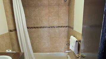 Deluxe Single Room | Bathroom | Bathtub, towels, soap, toilet paper