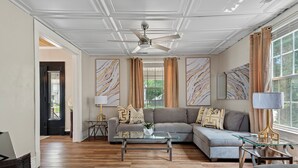 A spacious living room with a sectional sofa, a glass coffee table, and a ceiling fan. - 6BR Springfield Getaway Sleeps 15 Fire Pit & BBQ (Springfield)