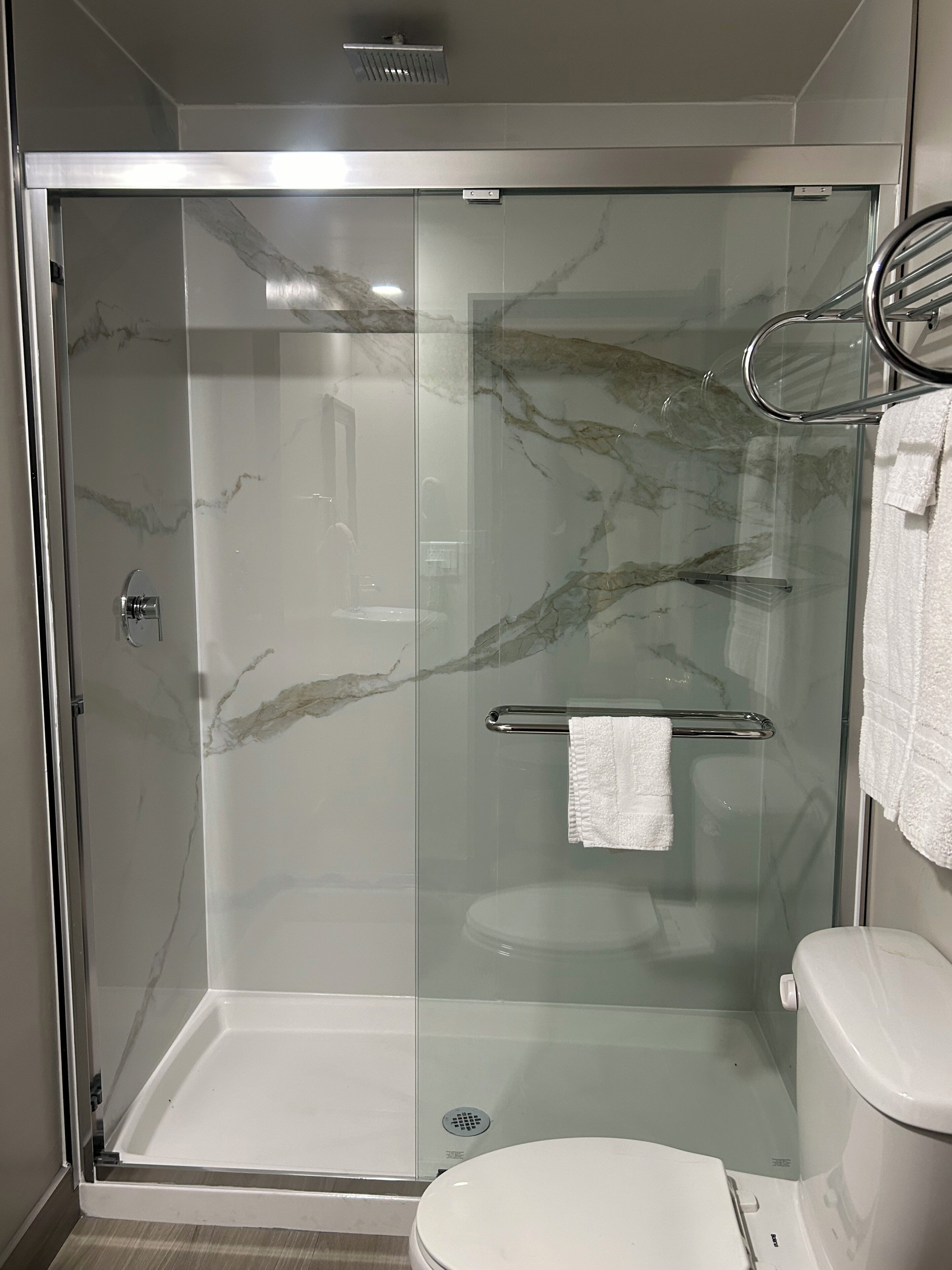 Shower, rainfall showerhead, hair dryer, towels
