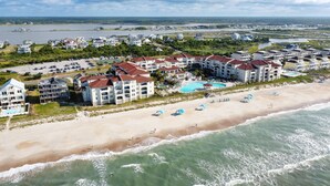 A coastal hotel with multiple buildings, a beach, and a swimming pool. - Oceanfront Resort! at Ocean Delight! (North Topsail Beach)