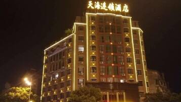 A multi-story hotel with illuminated signage at the top.