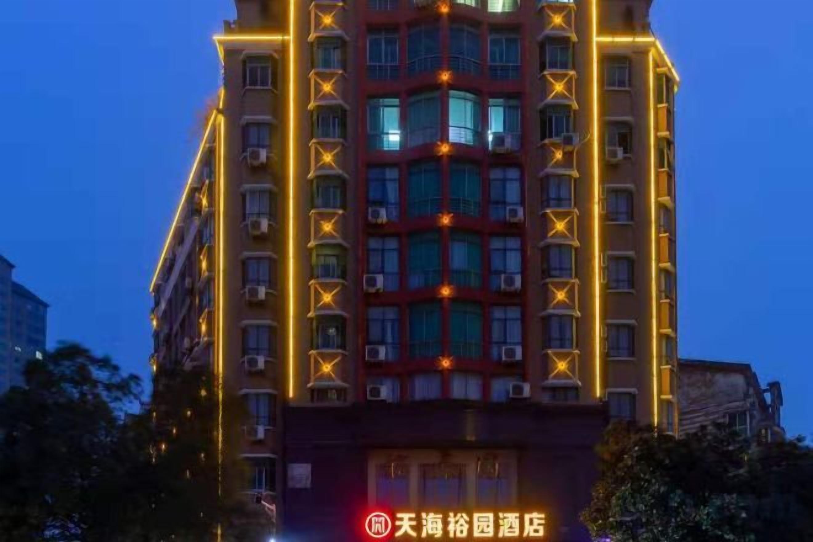 A multi-story hotel building with illuminated signage and windows.