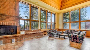 A spacious living area with a brick fireplace, large windows, and comfortable seating. - Mountain Dream in Adorable Frisco - 5 Ski Resorts and Lake Dillon (Frisco)