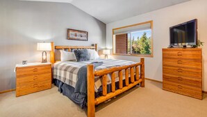 A bedroom with a wooden bed, a nightstand, a dresser, and a television. - Mountain Dream in Adorable Frisco - 5 Ski Resorts and Lake Dillon (Frisco)