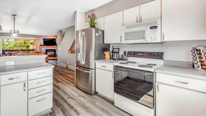 A modern kitchen with stainless steel appliances, white cabinetry, and a built-in microwave. - Mountain Dream in Adorable Frisco - 5 Ski Resorts and Lake Dillon (Frisco)
