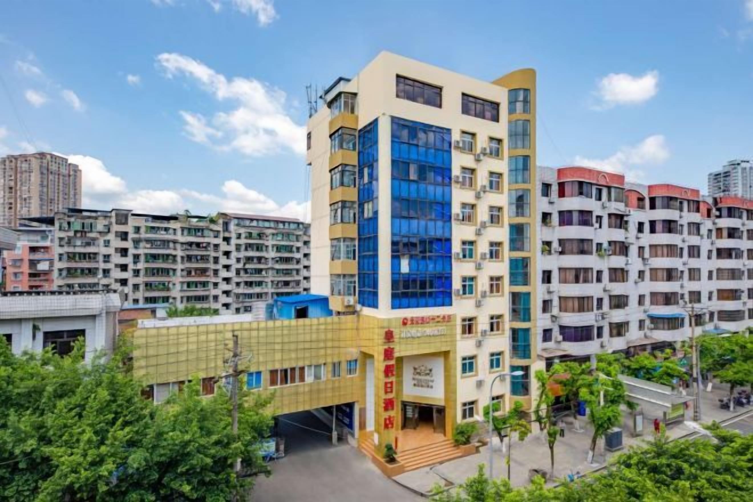 A multi-story building with a prominent entrance, surrounded by other residential buildings.