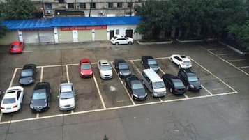A parking lot with multiple cars parked in designated spaces.
