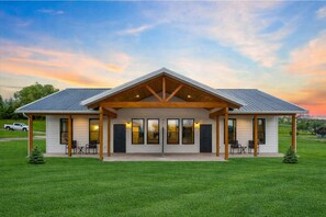 A modern two-story house with a covered front porch, large windows, and a well-maintained lawn. - Spacious 2BR Duplex in Polson MT – Family Getaway Near Flathead Lake & Glacier (Polson)