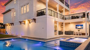 A two-story house with a swimming pool, outdoor seating, and a kitchen area. - Casa Blanca | Rooftop Bar • Elevator • Golf Cart • 400' Beach Access (Miramar Beach)