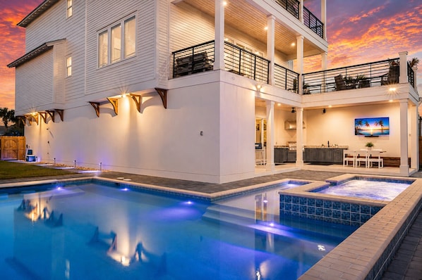 A two-story house with a swimming pool, outdoor seating, and a kitchen area. - Casa Blanca | Rooftop Bar • Elevator • Golf Cart • 400' Beach Access (Miramar Beach)