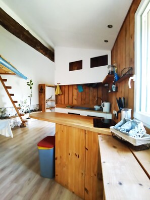 A kitchen with wooden cabinets, a central island, and a window.