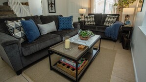 A living room with two grey sofas, a coffee table, and a staircase in the background. - Tranquil Retreat 4 Miles to Park Entrance Walk to Dining BBQ Balcony (Three Rivers)