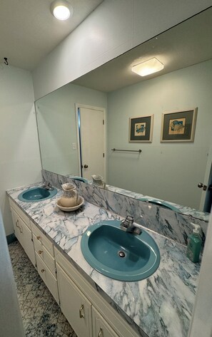 A bathroom with two sinks, a mirror, and a door. - Stunning waterfront views; 4-bedroom house directly on Intracoastal waterway! (Hubert)