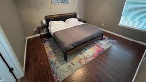 A bedroom with a bed, a ceiling fan, a window with blinds, and a door. - Amazing 3-bedroom home with 2 full baths. Spacious fenced backyard. WiFi present (Fort Smith)