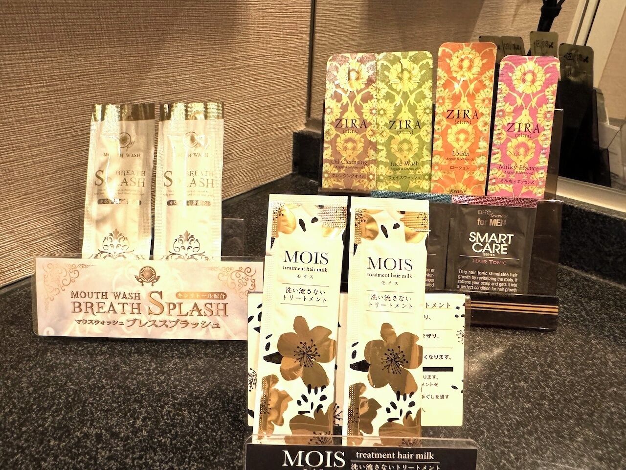 A display of various hair care products including brands like ZIRA and MOIS, arranged on a countertop.