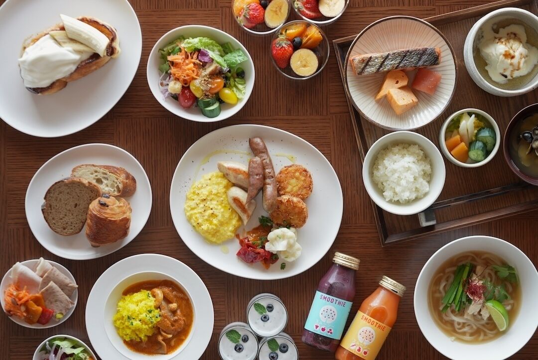 A variety of dishes including sushi, rice, and a smoothie bottle.