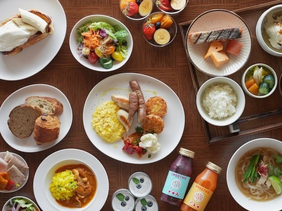 A variety of dishes including sushi, rice, and a smoothie bottle.