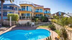 A multi-story residential building with a swimming pool in the foreground. - Baywatch 3 - Best Location & A View! (Merimbula)