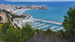 A coastal marina with numerous boats docked, a beach, and a cityscape in the background. - Mar de Oropesa II by Interhome (Oropesa del Mar)