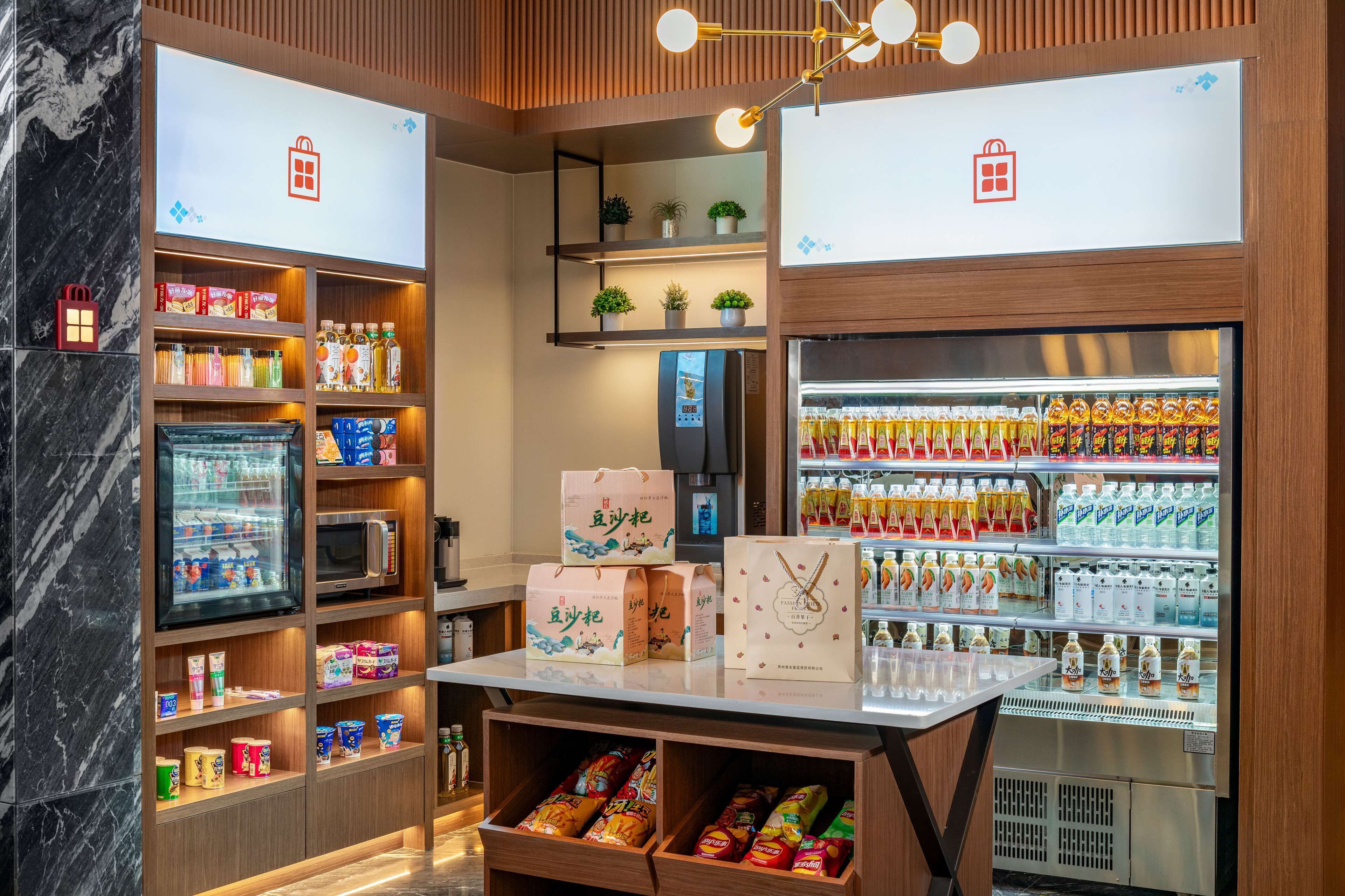 A well-organized retail space with shelves stocked with snacks, beverages, and packaged goods.