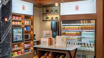 A well-organized retail space with shelves stocked with snacks, beverages, and packaged goods.