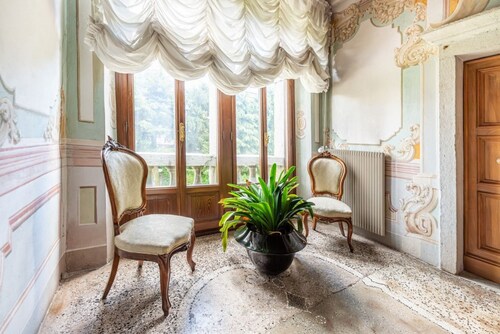 Elegant 350 sqm apartment for 6 people, located on two levels of a historic 18th century villa. The villa, with fine furnishings and frescoed galleries, will enchant you with its rooms, where history and comfort blend to give you an unforgettable experie