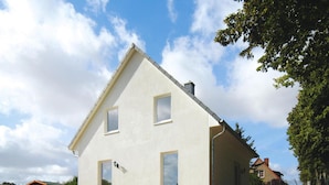 A modern two-story house with a sloped roof, a front porch, and a staircase leading to the entrance. - Ferienhaus Kiebitz, Plau am See (Plau am See)