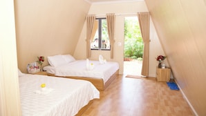 A bedroom with two beds, a window, and a door leading outside. - Xanh Homestay (Phu Cat)