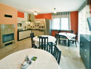 Cozy living space with a kitchen, dining area, and fireplace, perfect for a meal.