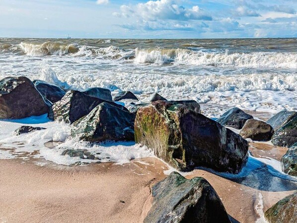 A rocky shoreline with waves crashing against the rocks.
