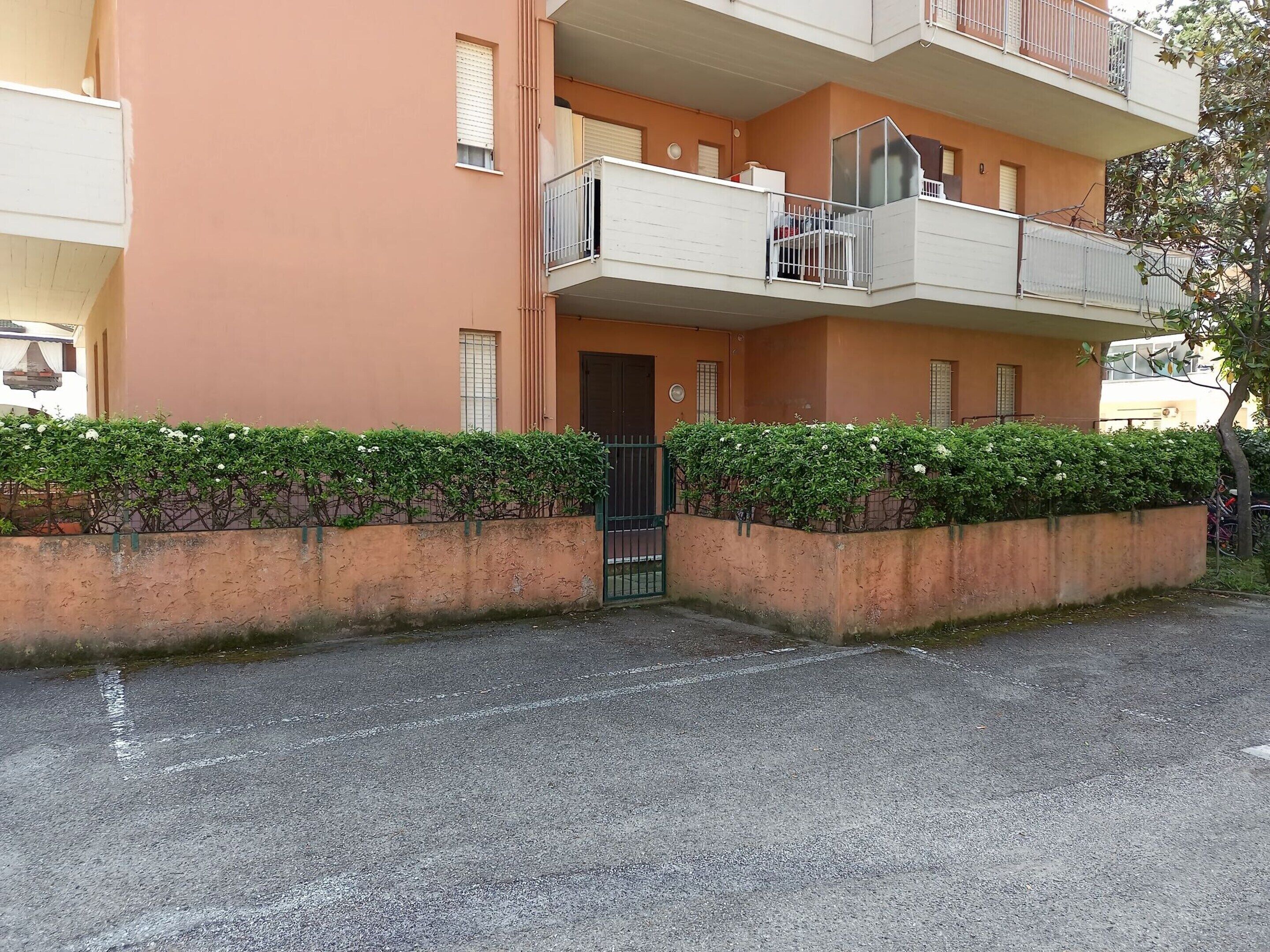 A two-story building with a balcony on the upper floor.