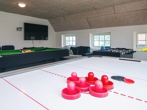 A recreational room with a pool table, foosball table, and billiards table. - 4 Star Holiday Home in Ulfborg (Ulfborg)