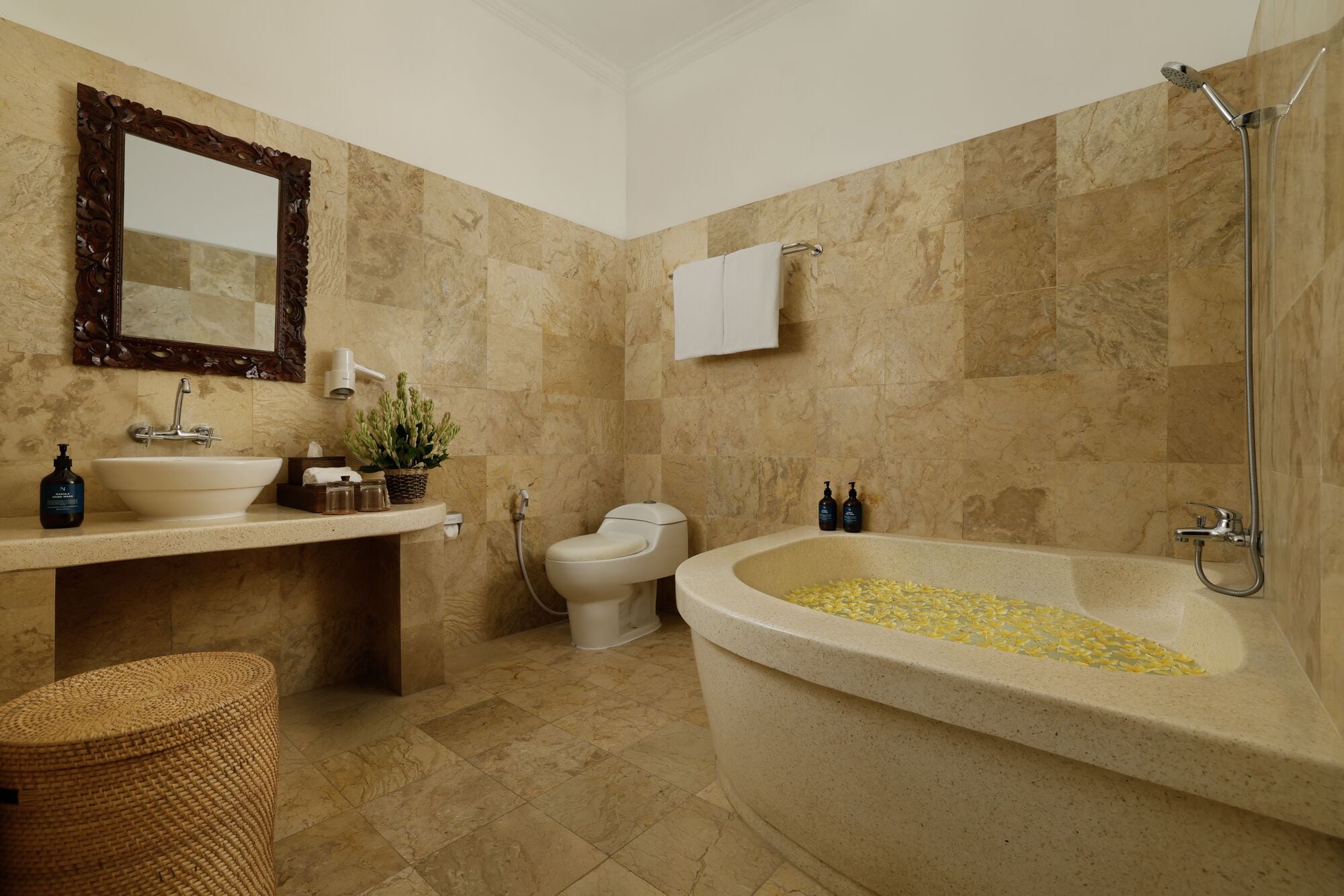 A bathroom with a freestanding bathtub, a sink, a toilet, and a shower.