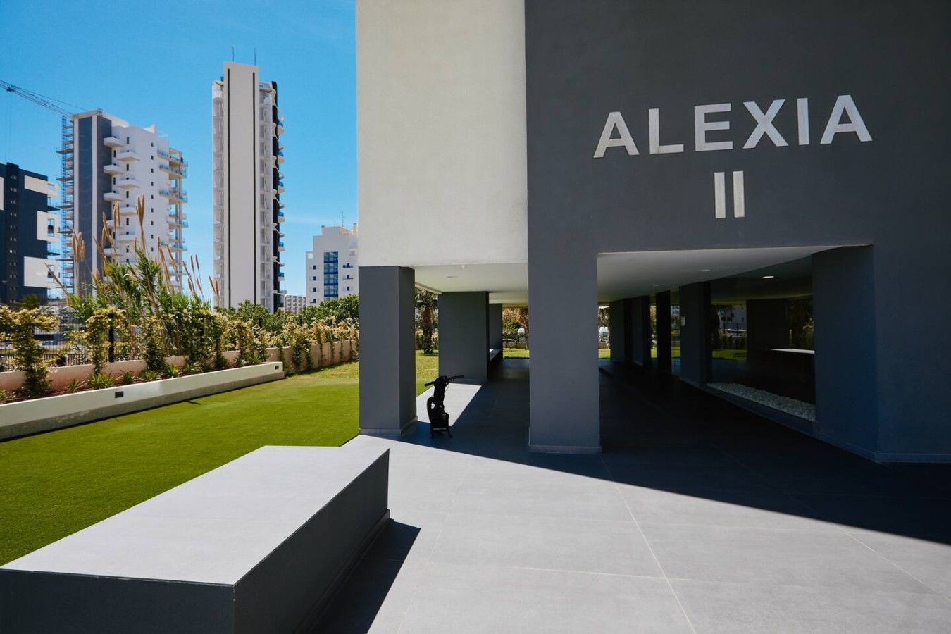 Un edificio moderno con el nombre 'ALEXIA II' en letras grandes.