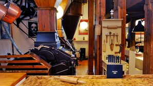 A kitchen with wooden cabinets, a coffee machine, and various kitchen utensils. - Hollaender Windmuehle in Neubukow (Neubukow)