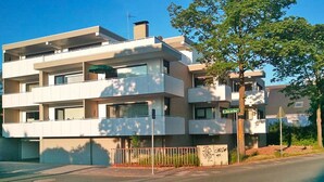 A modern multi-story residential building with balconies and large windows. - Apartment, Cuxhaven (Cuxhaven)