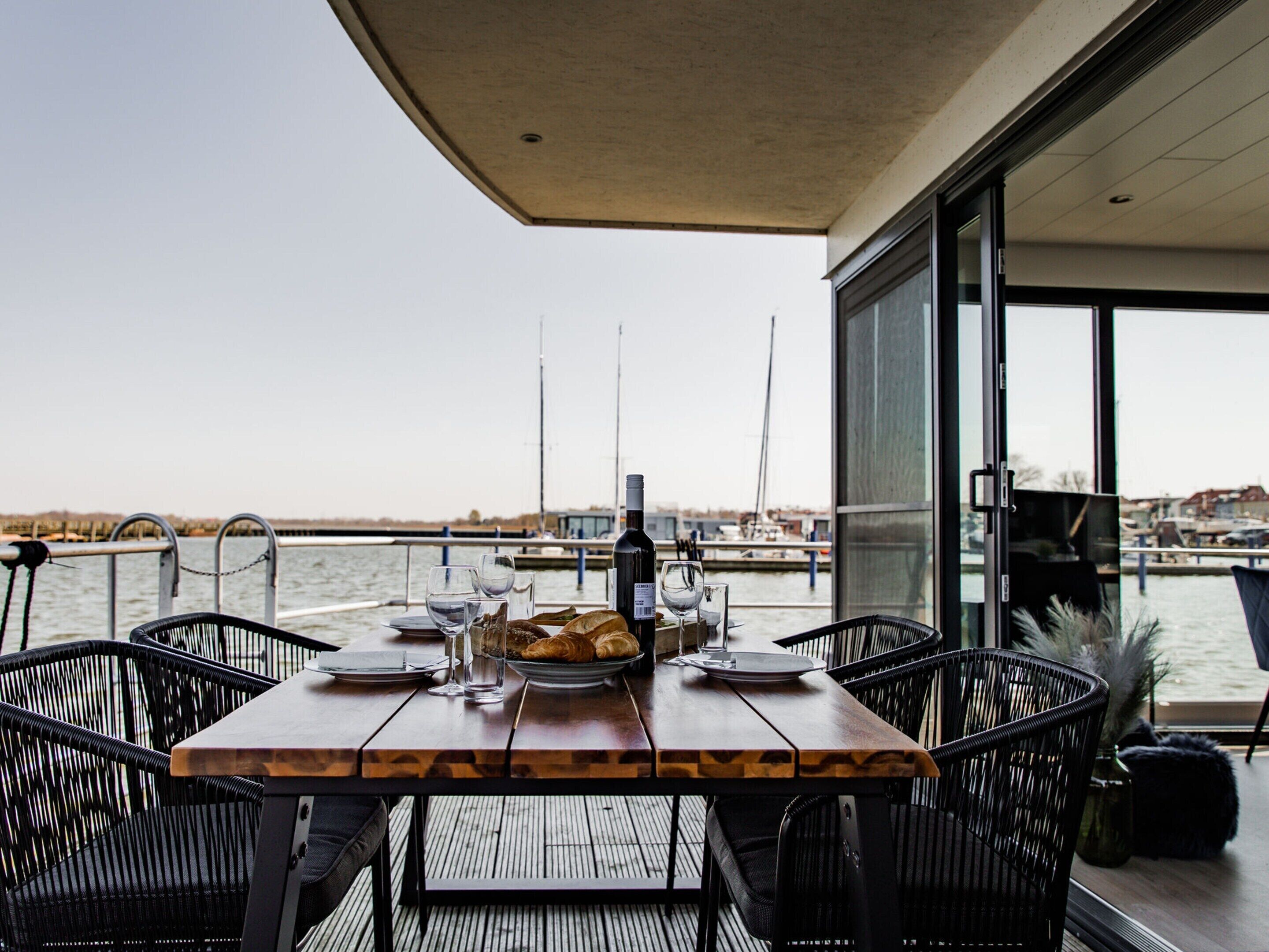 A table set for two with a view of the marina.