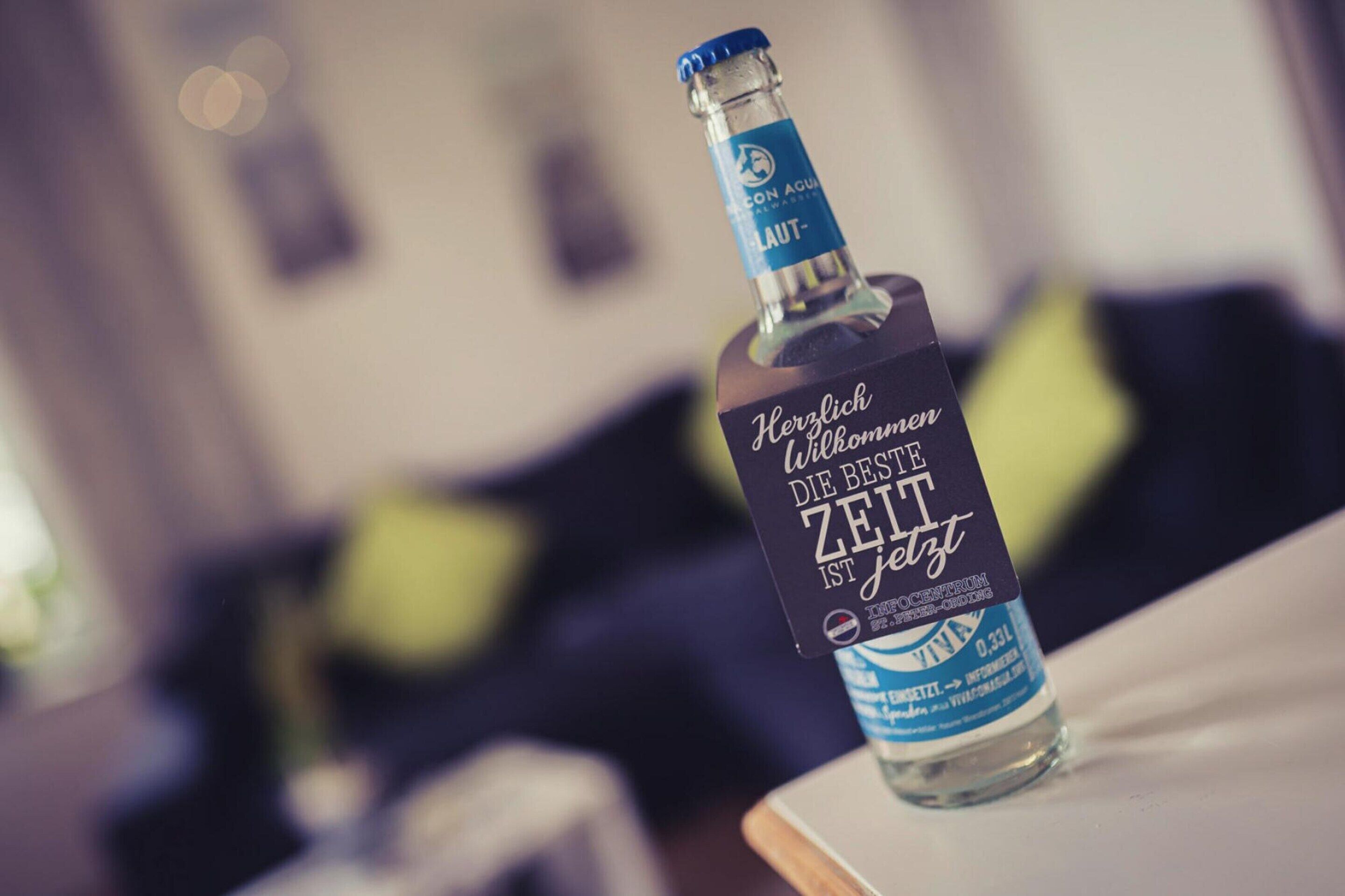 A bottle of alcohol on a table with a blurred background.