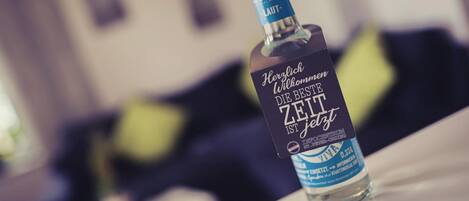 A bottle of alcohol on a table with a blurred background.