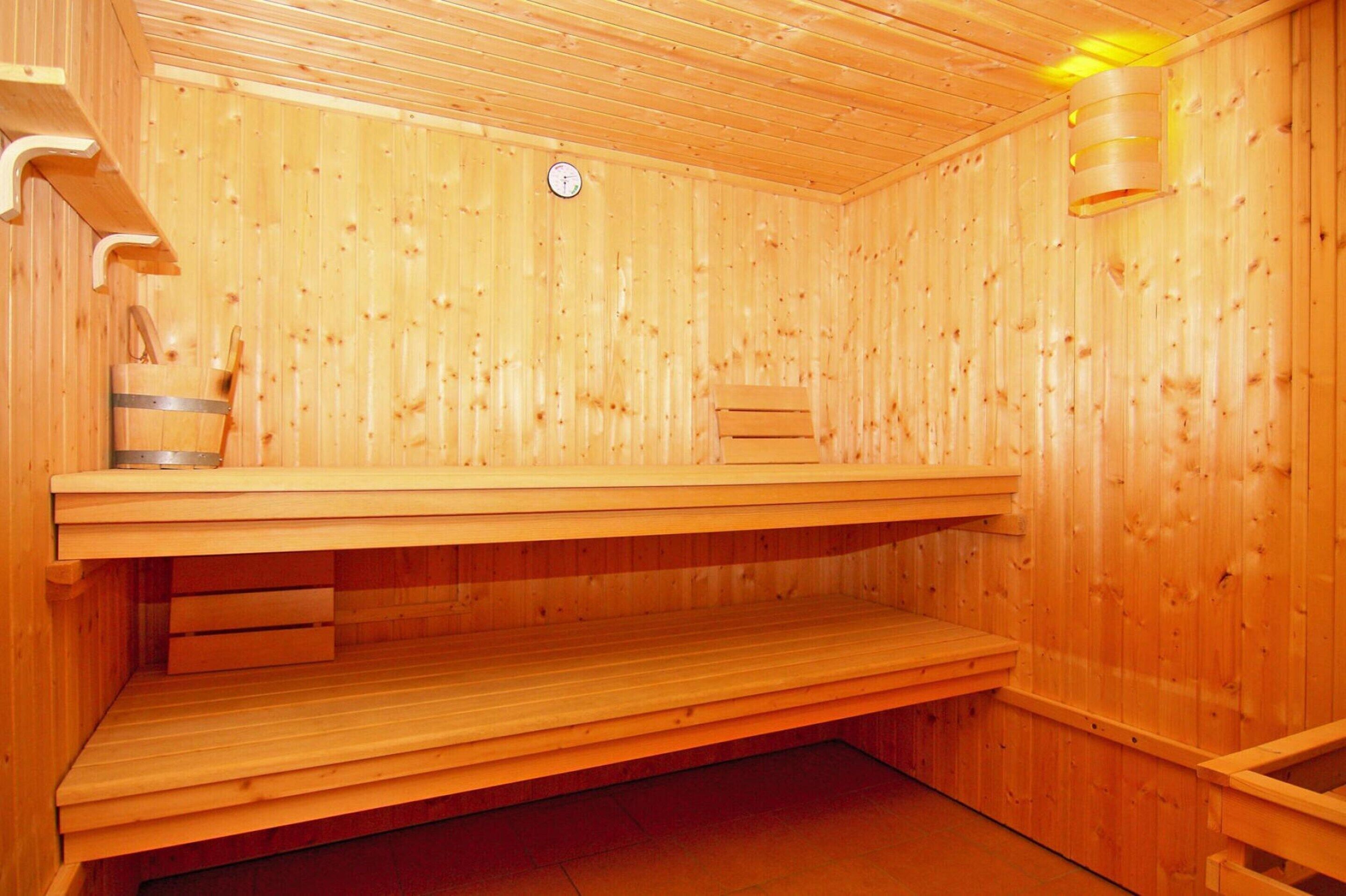 A sauna with wooden walls and benches.