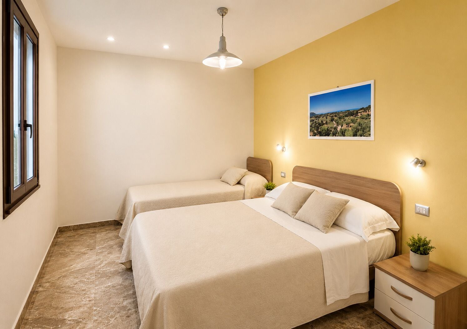 A hotel room with two beds, a nightstand, a potted plant, and a wall-mounted picture.