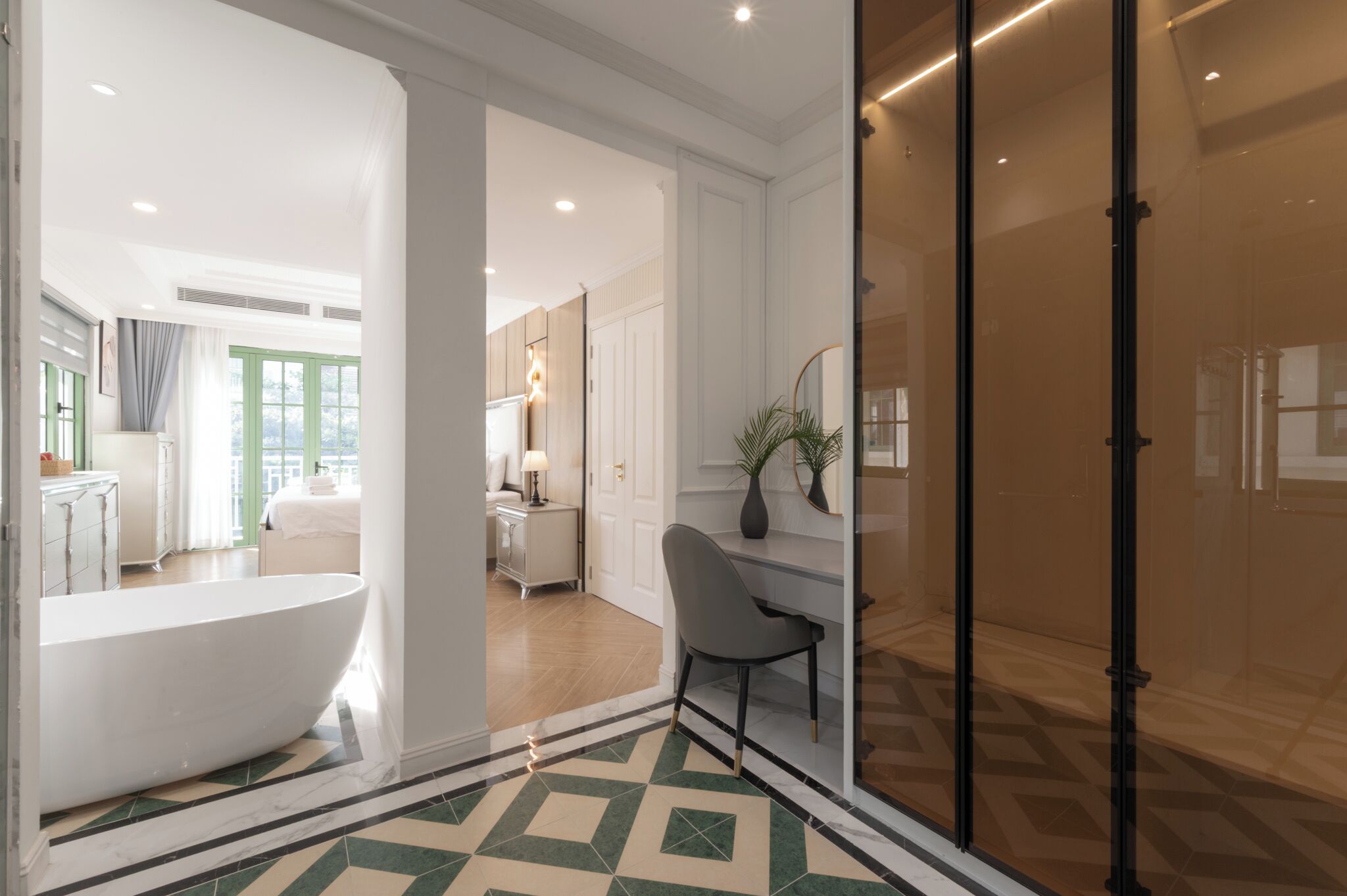 A modern bathroom with a freestanding bathtub, a vanity, and a mirror.